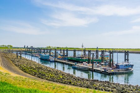 big jetty with docked boats in the harbor of Tholen, Bergse diepsluis, oosterschelde, zeeland, The netherlands, 22 april, 2019のeditorial素材