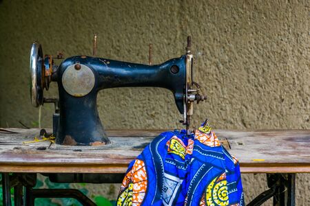 old vintage sewing machine with a fabric, Nostalgic equipment, Tailoring backgroundの写真素材
