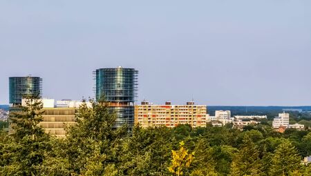 view on the city buildings from the forest of apeldoorn, popular dutch city, The netherlands