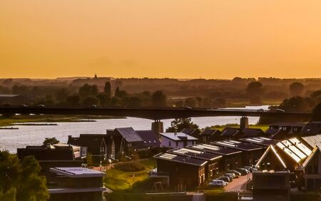 view on modern houses and the city bridge in rhenen during sunset, Rustic town in the Netherlands