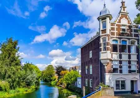 classical residential building at the canal in dordrecht, The netherlands, vintage city architectureの写真素材