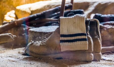 typical mountain climb shoes with a white sock in it, basic survival equipment