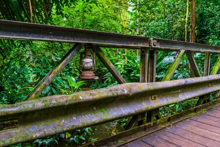 old rusty vintage lantern on a bridge in a jungle scenery, Architecture in natureの写真素材