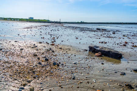 mudflats on breskens beach with rocks, coastal landscape, Zeeland, The Netherlandsの写真素材