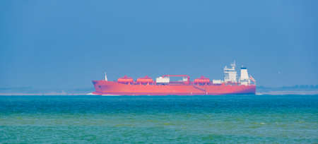 Red tanker ship transporting cargo near breskens and vlissingen, Zeeland, The Netherlandsの写真素材