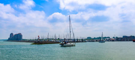 The beautiful harbor of Breskens with a boat sailing by, Breskens, Zeeland, The Netherlands, 20 July, 2020のeditorial素材