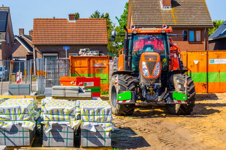 parked industrial tractor from the brand New Holland, Construction site in Rucphen, The Netherlands, 6 may, 2022のeditorial素材