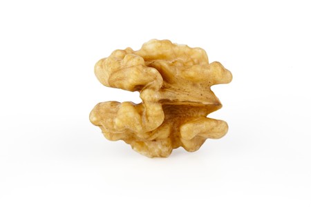 Two raw shelled walnut halves on white background