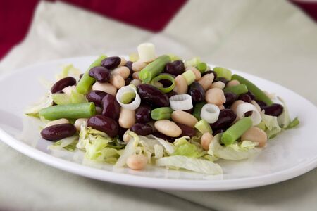 Three bean salad with cannellini, kidney and green beans, on a bed of iceberg lettuce.の写真素材