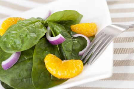 Fresh Spinach with mandarin oranges, red onions and a light orange honey dressing.の写真素材