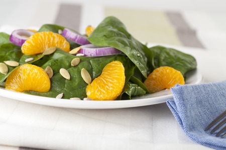 Fresh Spinach with mandarin oranges, red onions and a light orange honey dressing.の写真素材