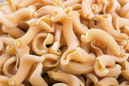Closeup of dried gigli pasta filling entire frame.の写真素材