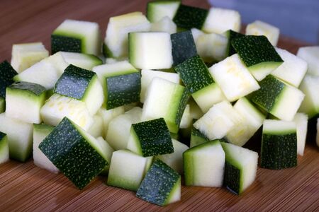 Zucchini chopped into cubes on cutting board.  の写真素材