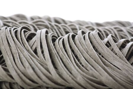 Ribbons of tagliatelle pasta on white background..の写真素材