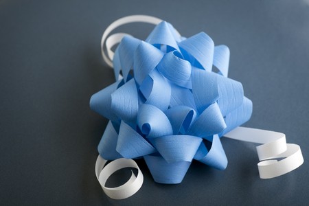 Close up of blue bow with white ribbons.の写真素材