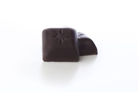 Pieces of dark chocolate isolated on white background.の写真素材