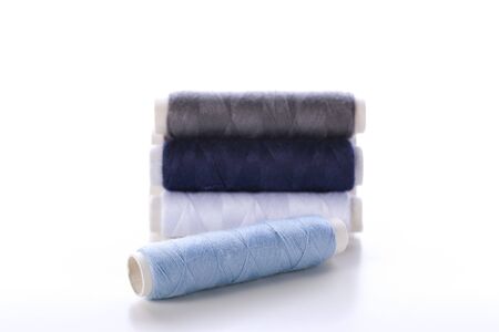 Blue and white threads on white background