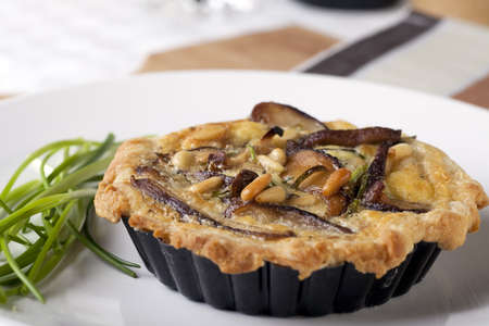 Small Quiche appetizer with shitake mushrooms and pine nuts.の写真素材
