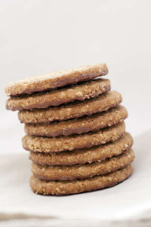 Stack of oatmeal cookies with bottom dippe in chocolateの写真素材