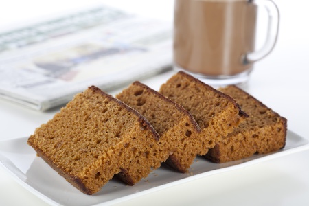 Dutch breakfast cake, often spiced with cloves cinnamon and nutmeg.  A coffee and newspaper in the...