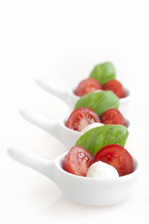 Fresh mozzarella, cherry tomato and basil appetizers.の写真素材