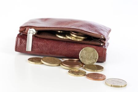 Change spilling from a leather coin purse.
