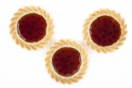 Three cookies filled with strawberry jelly isolated on white background.の写真素材