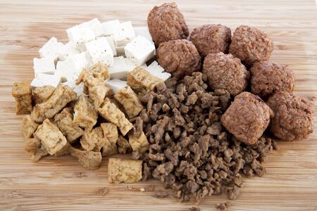 Various vegetarian products, raw tofu, marinated tofu, ground and ball soy protein.の写真素材