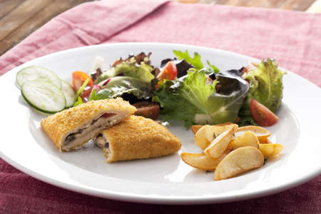 Vegetarian version of courdon blue with salad and rosemerry potatoes.