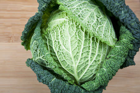 Head of curly green leaf cabbage on cutting board.  Angle of view from directly above.の写真素材