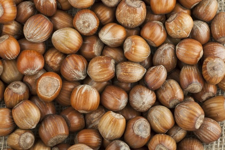 Pile of whole unshelled hazelnuts seen from above 