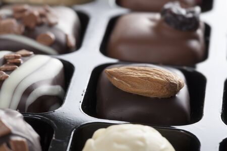 Gourmet chocolates topped with an almond の写真素材