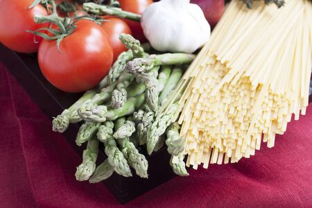 Ingredients for linguini dinner with asparagus and tomatoes の写真素材