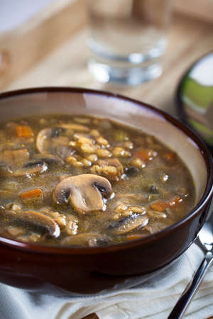Bowl of barley and Mushroom soup verticalの写真素材