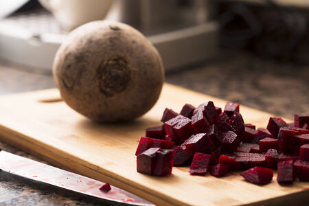 Chopped and whole beetroot on cutting board.の写真素材
