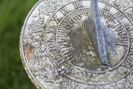 Close up of weathered  sundial in gardenの写真素材