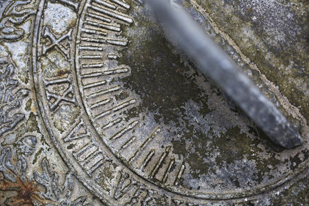 Close up of weathered  sundial in gardenの写真素材