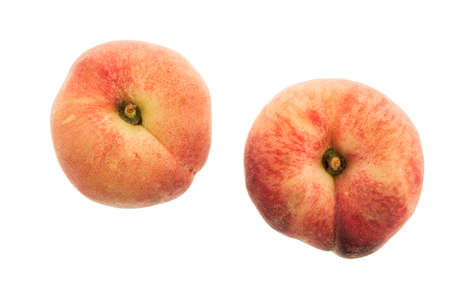 Two flat peaches isolated on whiteの写真素材