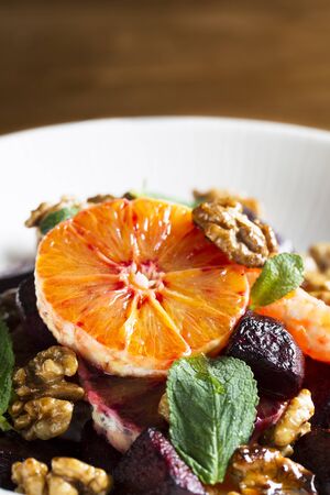 Beetroot and Orange salad with walnuts and mint leaves.の写真素材