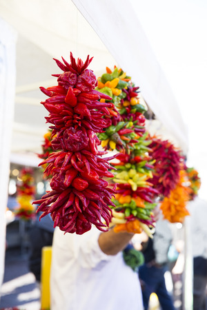 Colorful peppers strung and hanging in market.の写真素材