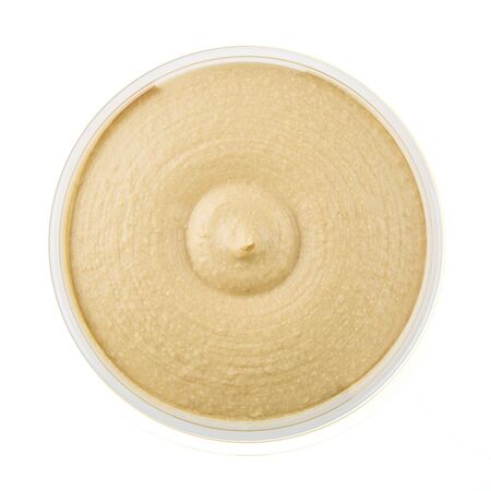 Healthy hummus in container from above and isolated on a white background.の写真素材