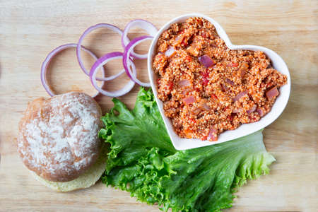 Heart healthy vegan sloppy joe sauce made with quinoa, with a bun, lettuce and onion.の写真素材