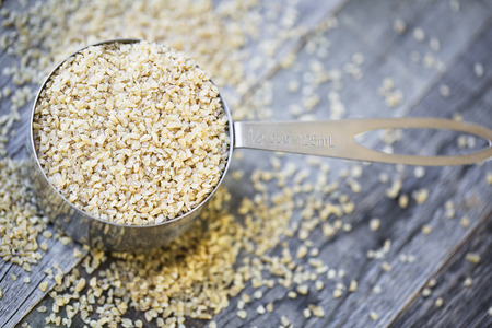 Half cup of raw bulgur wheat ready for recipe.の写真素材