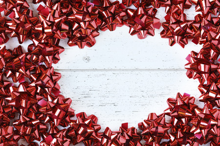 Many red decorative bows for Christmas or other gifts, with copy space.の写真素材