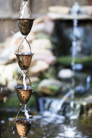 Unique copper cups used as a garden water fountain.の写真素材