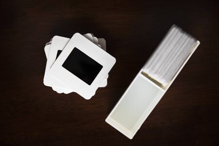 Old slide film transparencies in cardboard frames and container.の写真素材