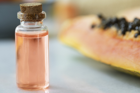 Small bottles of papaya extract with papaya fruitの写真素材