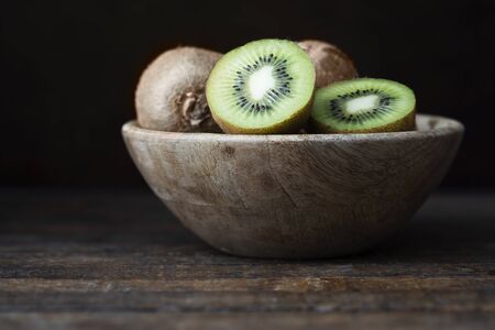 Kiwis in Wooden Bowlの写真素材