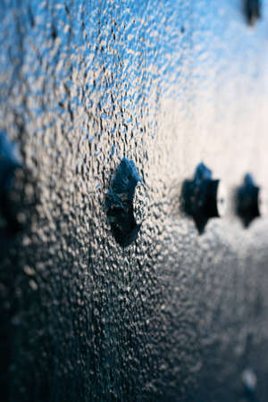 Close up on an old metal Bolt painted in green. abstract. Verticalの写真素材