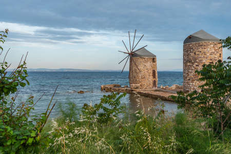 Landmark Chios air mills, foreground with grass on a cloudy day. Horizontal. Side view. space for text.の写真素材